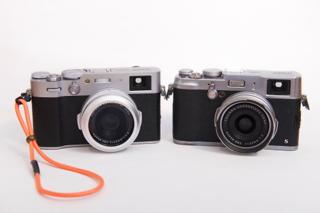 Two black and silver cameras side-by-side.