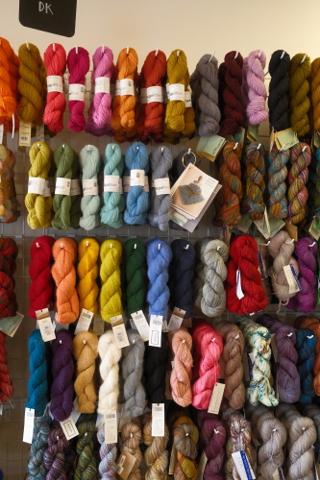 A wall full of yarn in different colors.