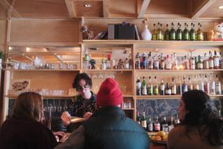 A bartender mixes a drink.