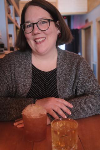 Smiling woman with a cocktail.