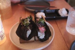 Hand rolls nestled on a pair of wooden holders.