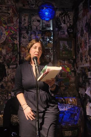 A woman author reading from her book.