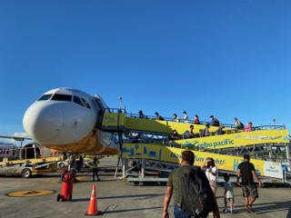 A winding ramp leads up to a small jet airplane.