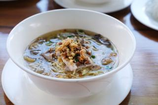 Closeup of a bowl of soup with noodles.