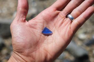Blue seaglass in a palm.