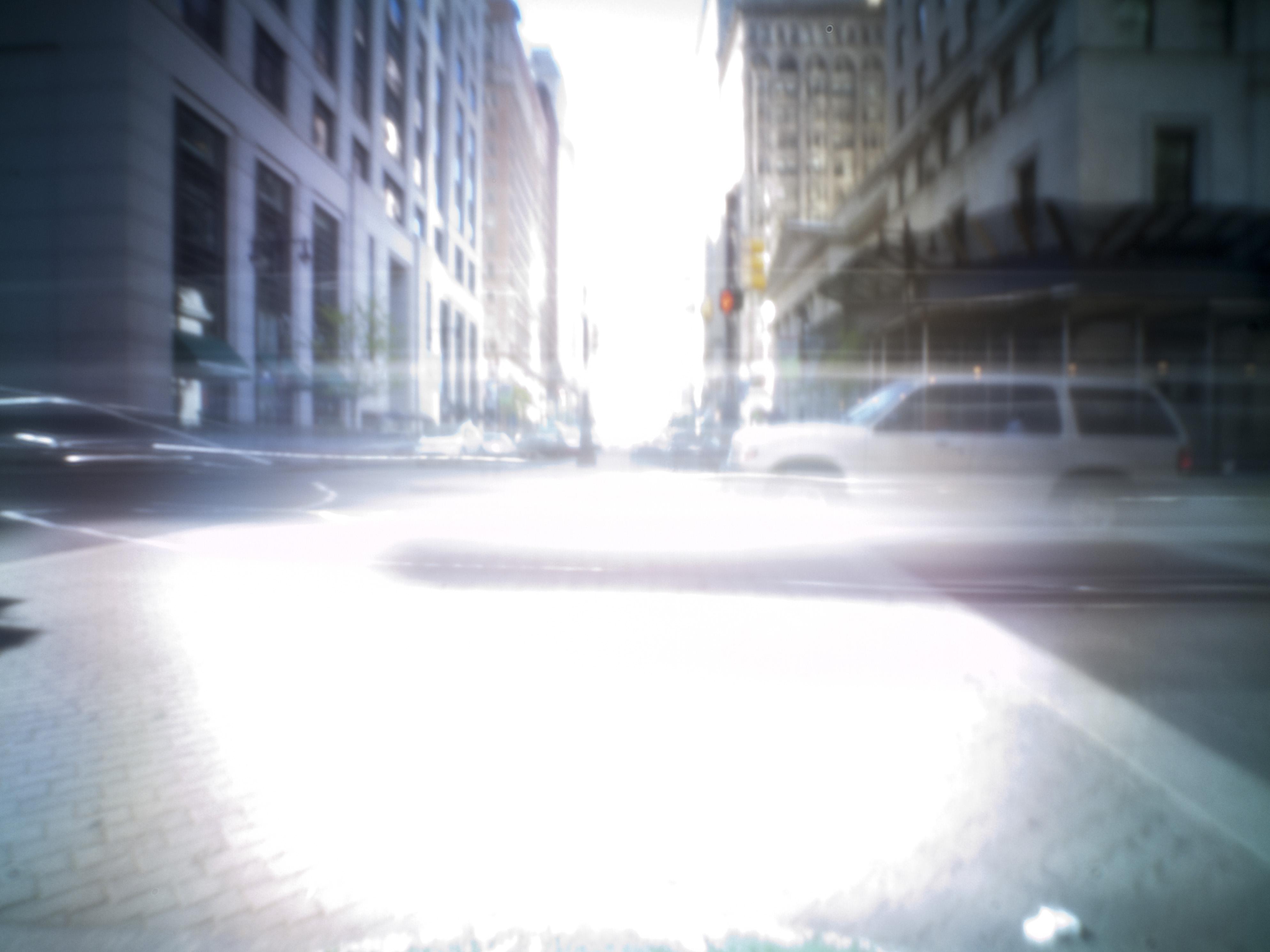 Pinhole photo of a street intersection.