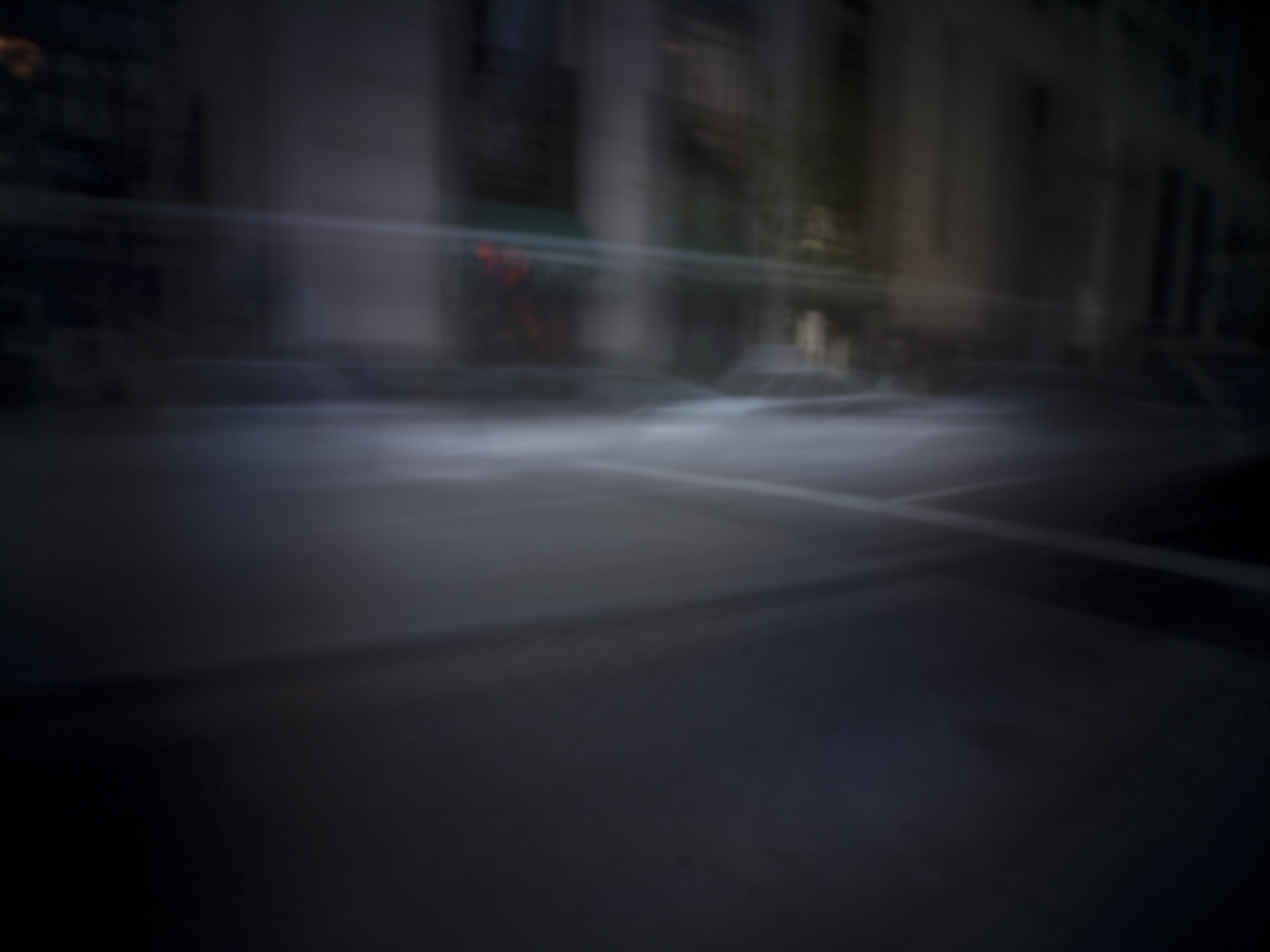 Pinhole photo of a street intersection.