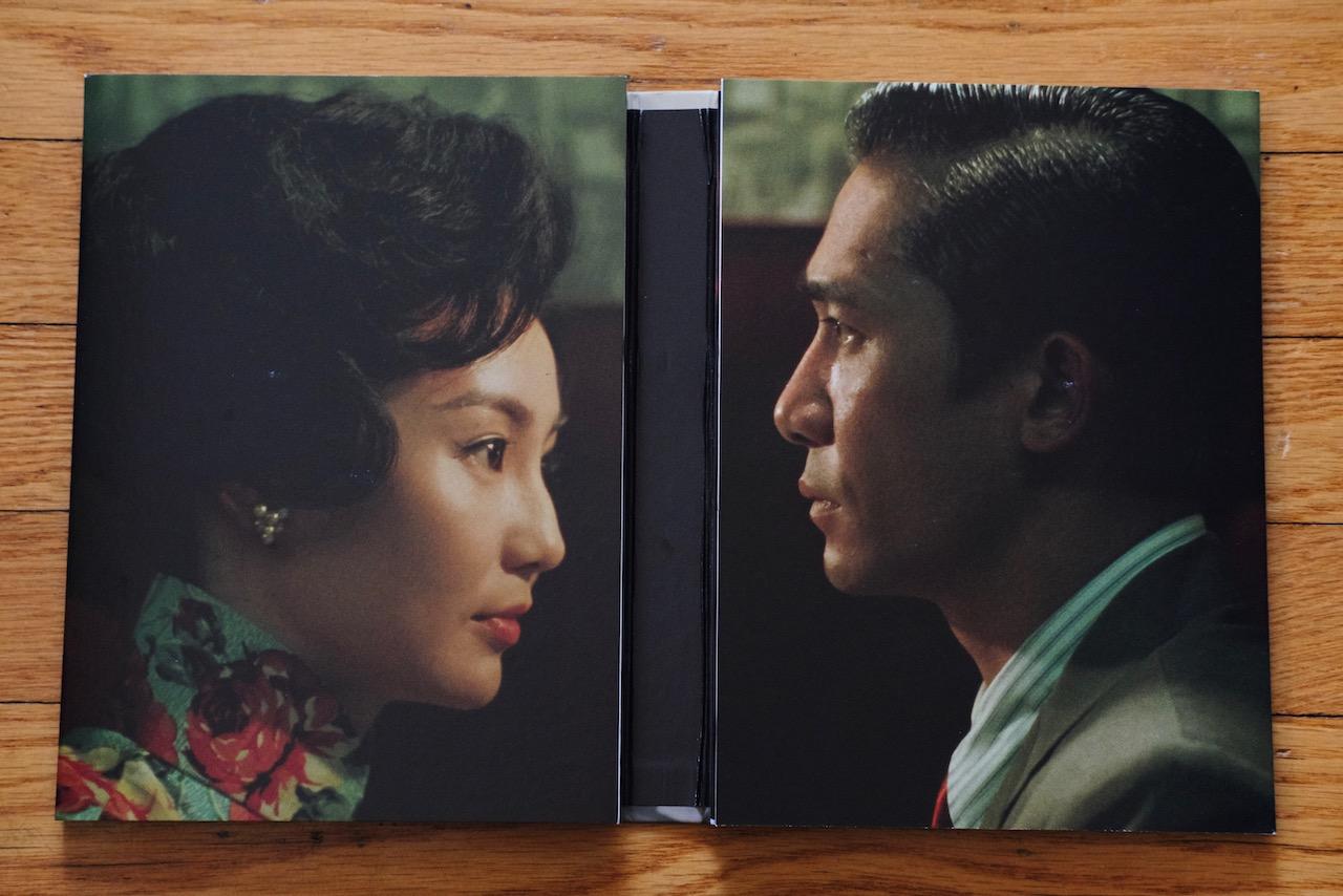 Disc booklet open to two profile images of a man and woman facing each other.