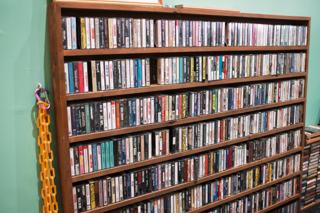 A shelf full of cassette tapes.