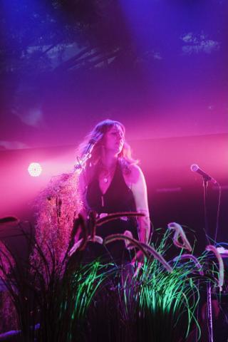 A singer vamps in front of the microphone.