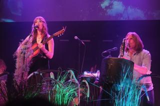 A singer and bandmate onstage.