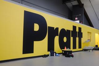 A large yellow wall with “Pratt” in a large black block typeface.
