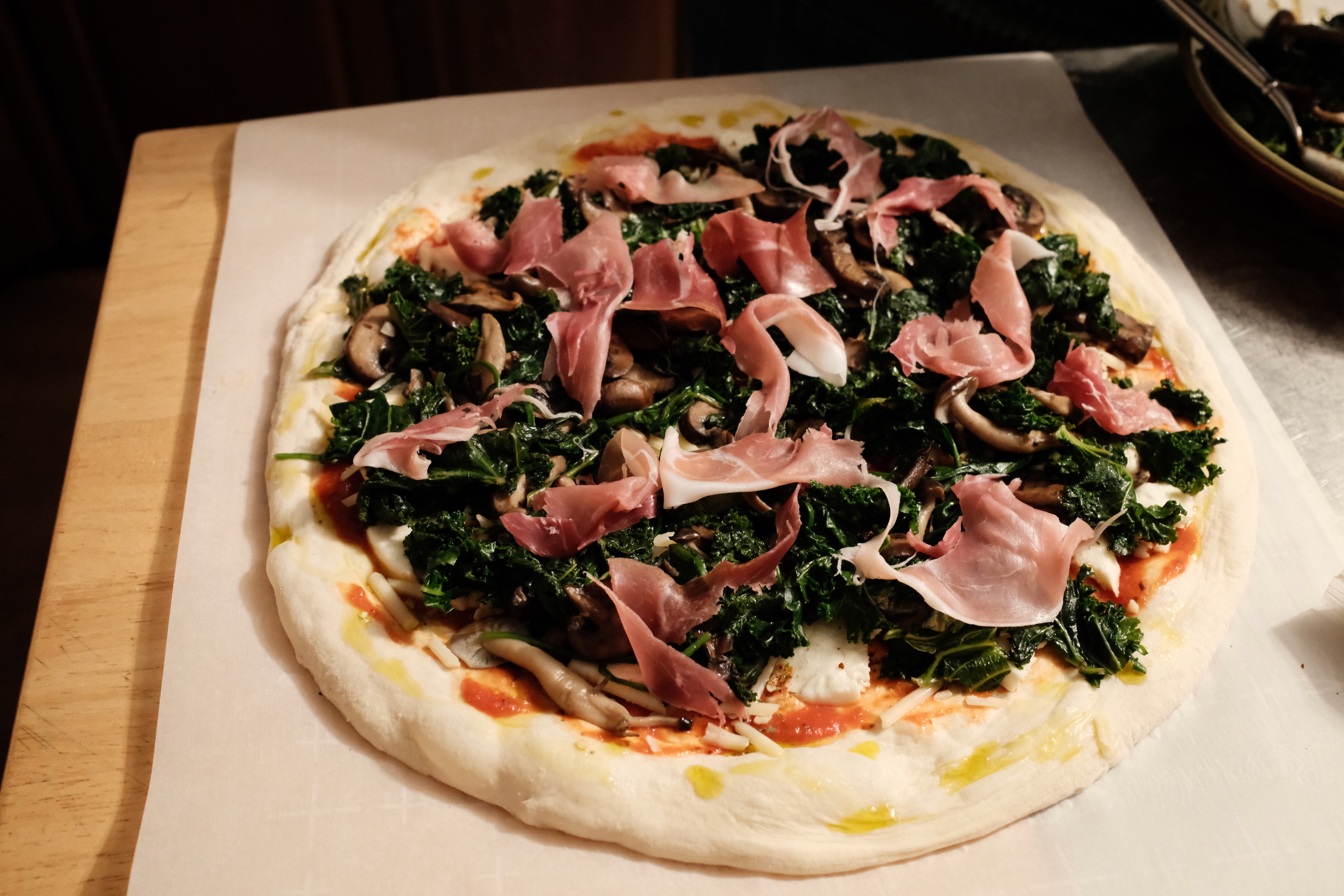 Fully assembled pizza, ready for the oven.
